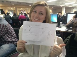 Rosie Hall holds up a rough sketch of upcoming product
