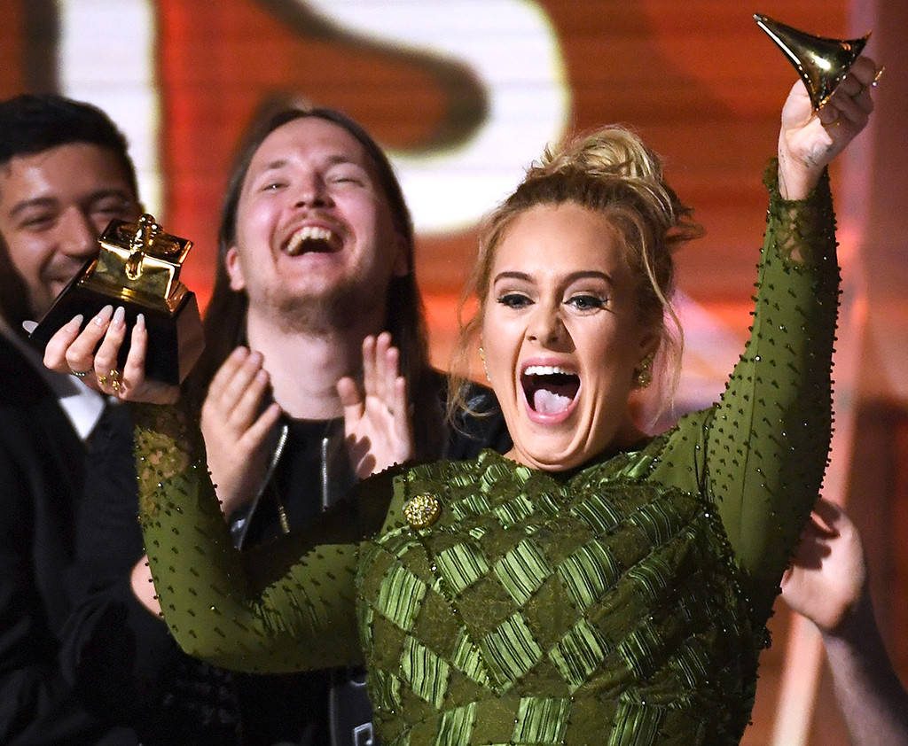 Photo: Kevork Djansezian/Getty Images Adele broke her grammy into to give to Bey after she won best abum of the year.