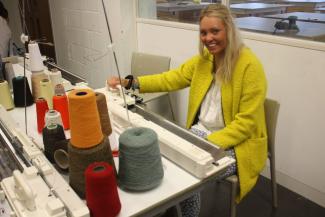 The KU student hard at work on her knitting machine