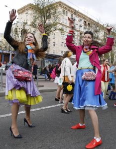 Young women brightly dressed for a parade. Credit: Rex Features, Vladimir Sindeyeve