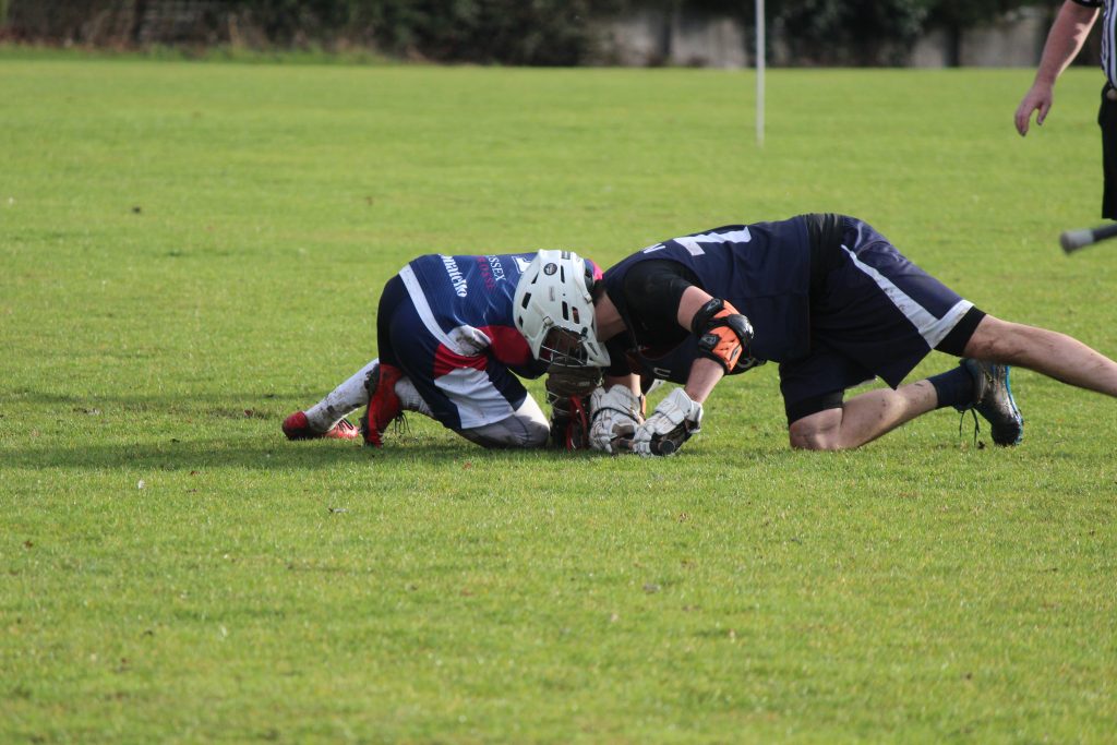 Nicoll fighting for possesion at face off against Sussex. Credit: Shani Kotecha