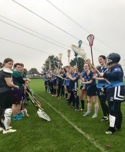 The team spirit was high when the lacrosse women met Royal Holloway (left).