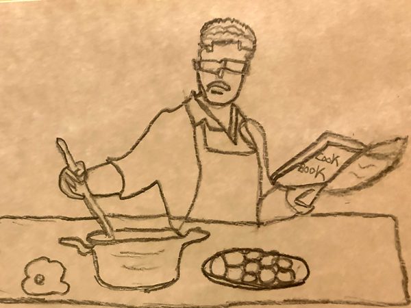 A man cooking while following the instructions from a cook book.