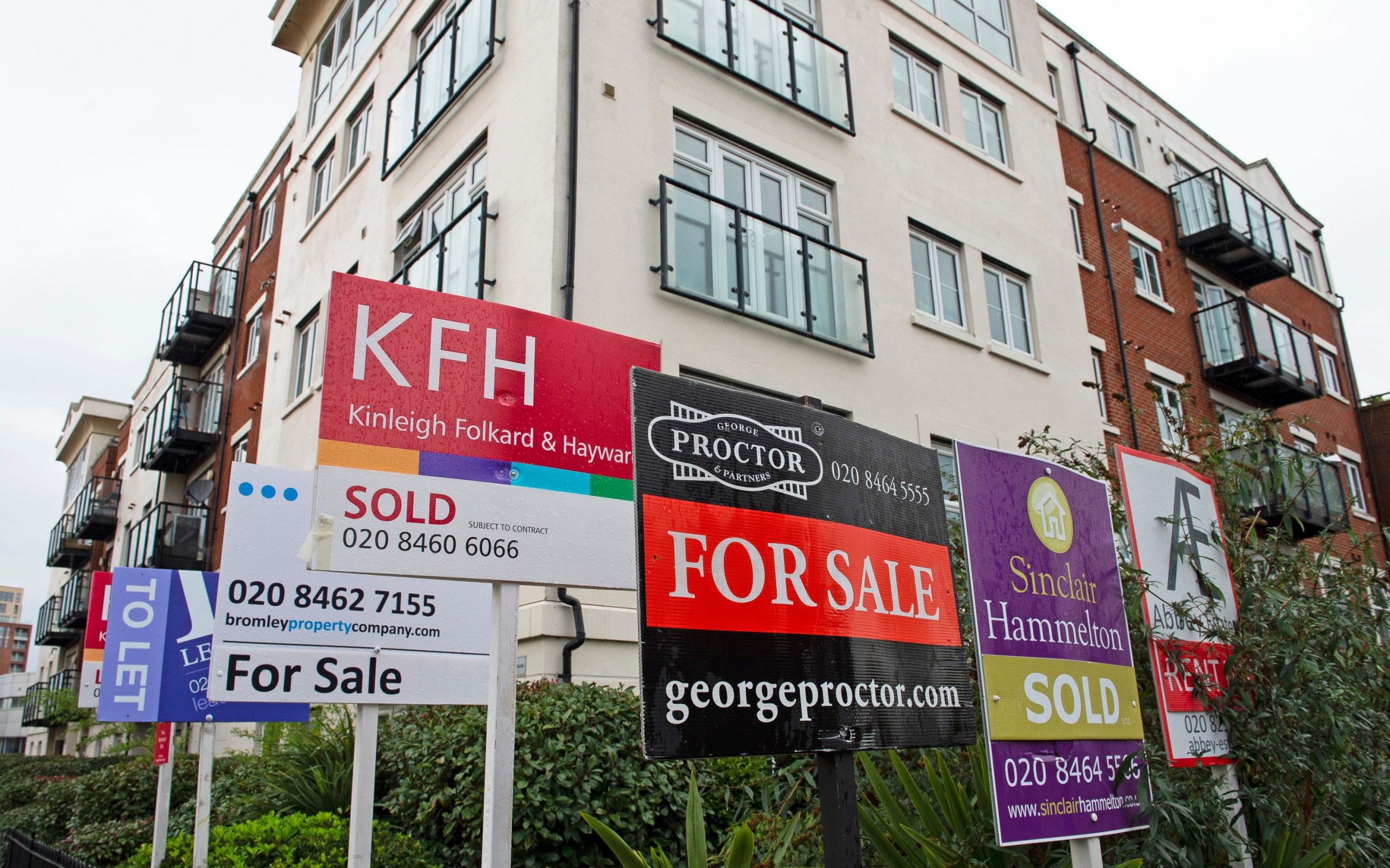 an image of several estate agent signs outside a building