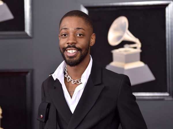 Brent Faiyaz posing with a big smile at the 60th annual Grammy Awards