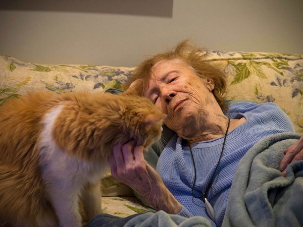 Image of an elder woman with her cat