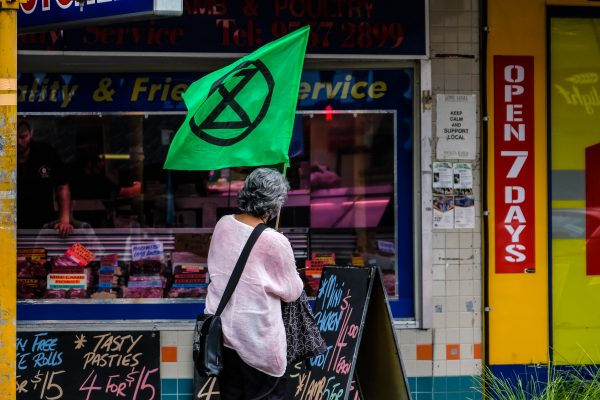 Extinction Rebellion activist protesting in front of a butcher