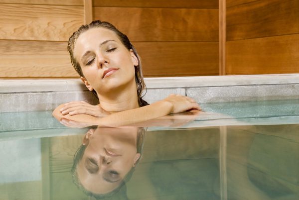 Woman relaxing in a hot bath