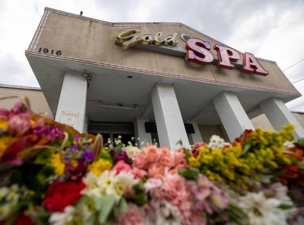 Image of a Spa in Atlanta, flowers left on the floor for the victims of the shooting