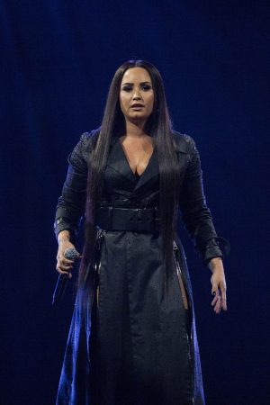 Demi Lovato singing on stage in London 2018