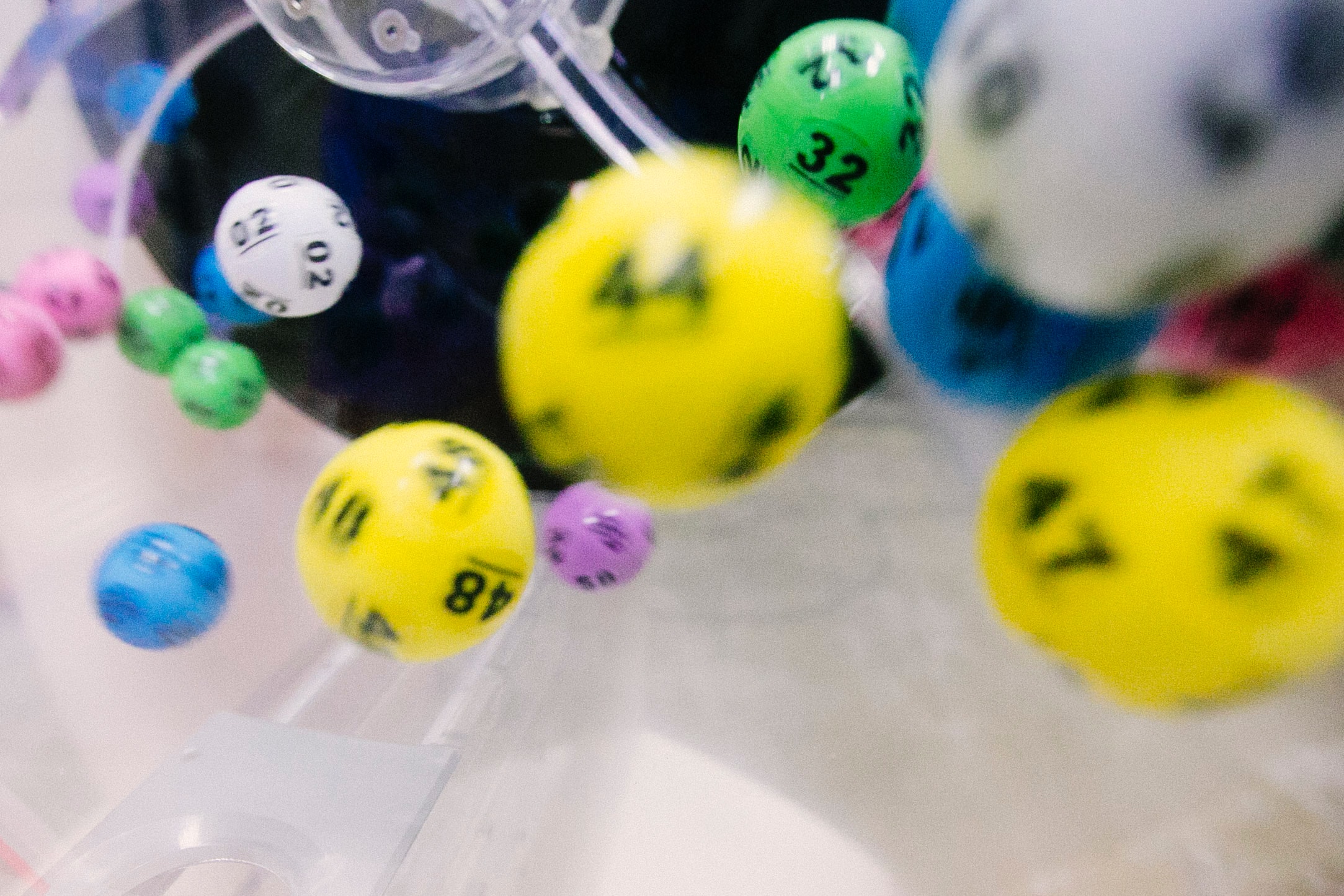 Yellow, white, green, purple and blue lottery balls spinning