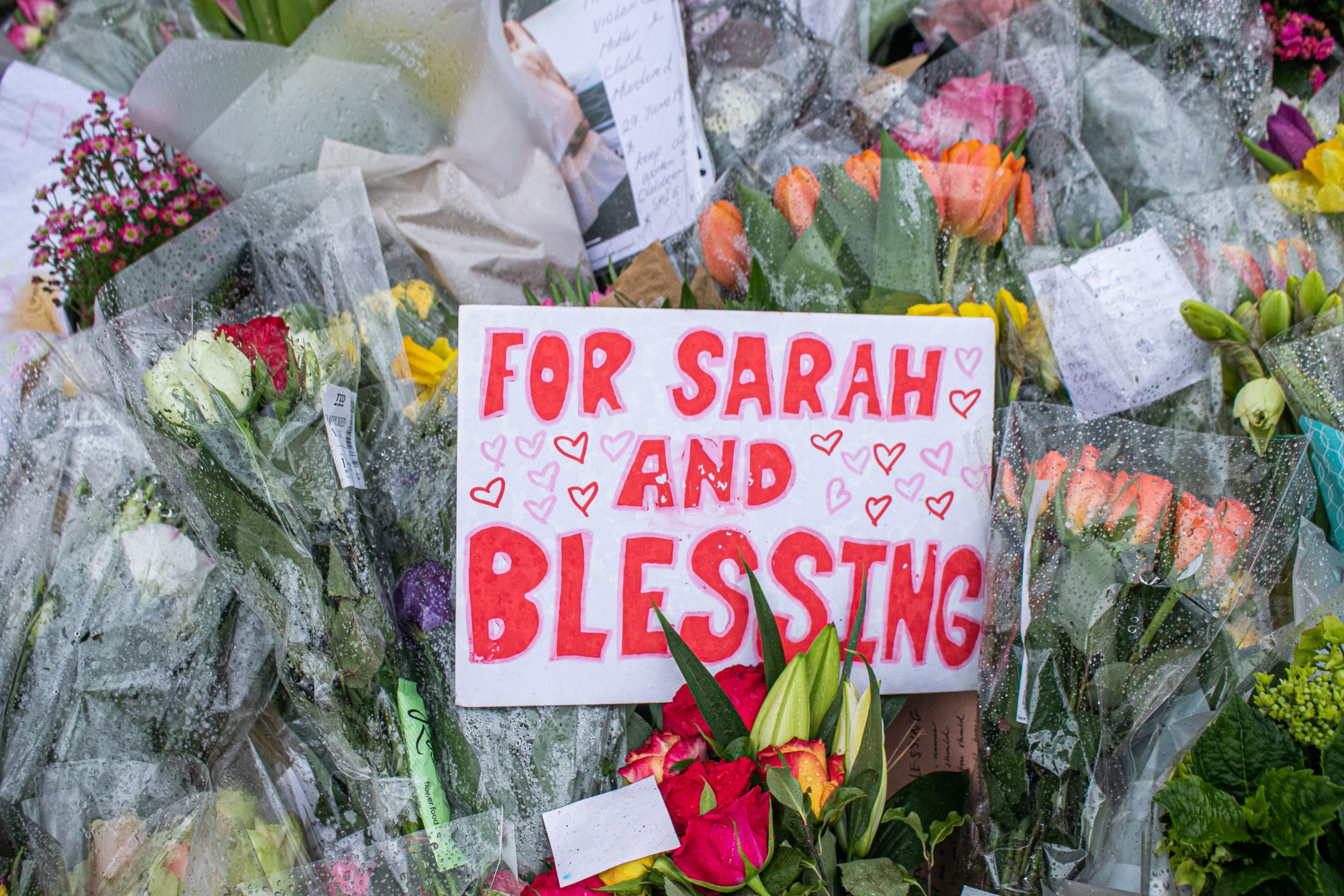 Flowers and sign saying "for Sarah and blessing".