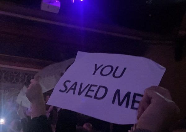 Fan holding up sign saying 'you saved me' at a James Arthur concert