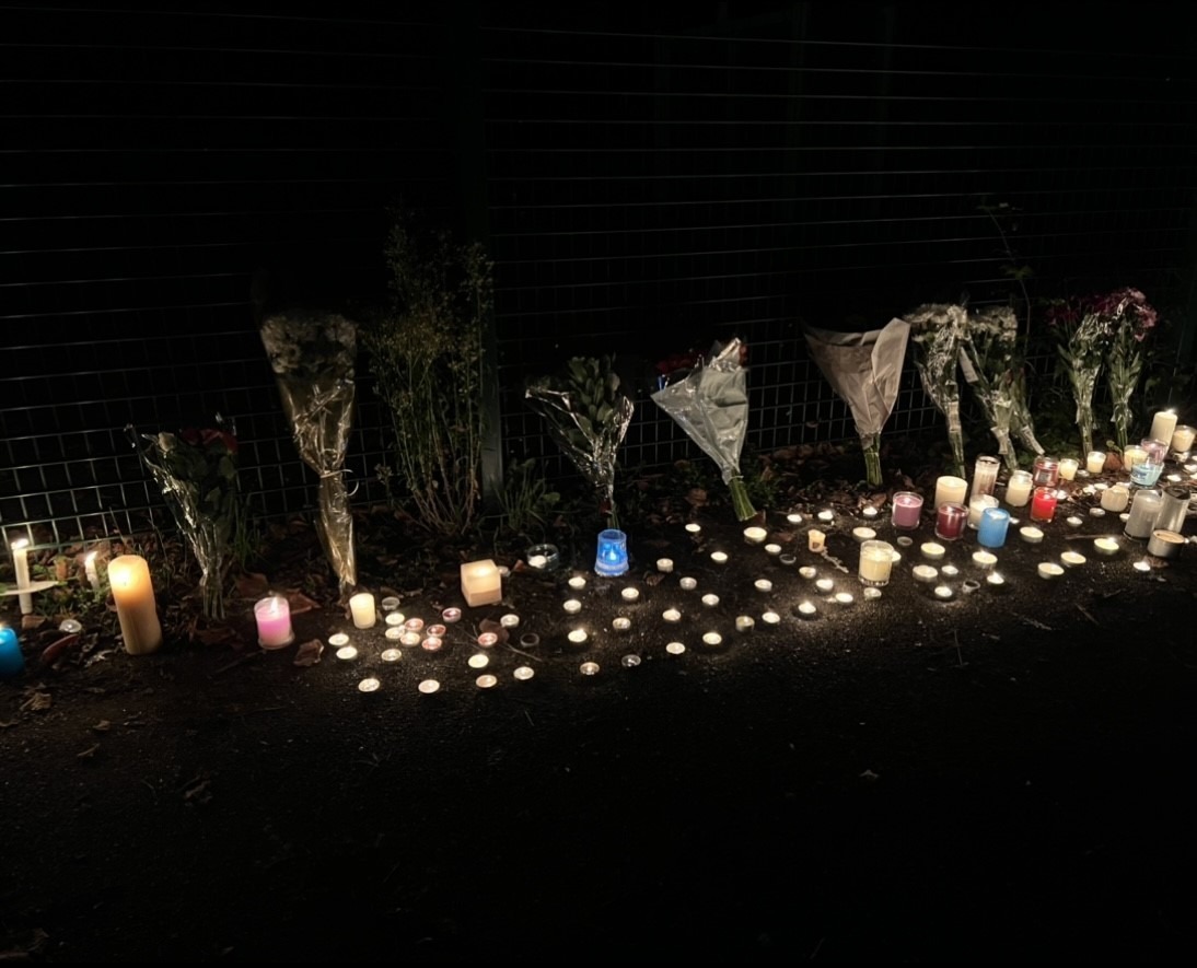 lit up candles and flowers for Ali's vigil. 