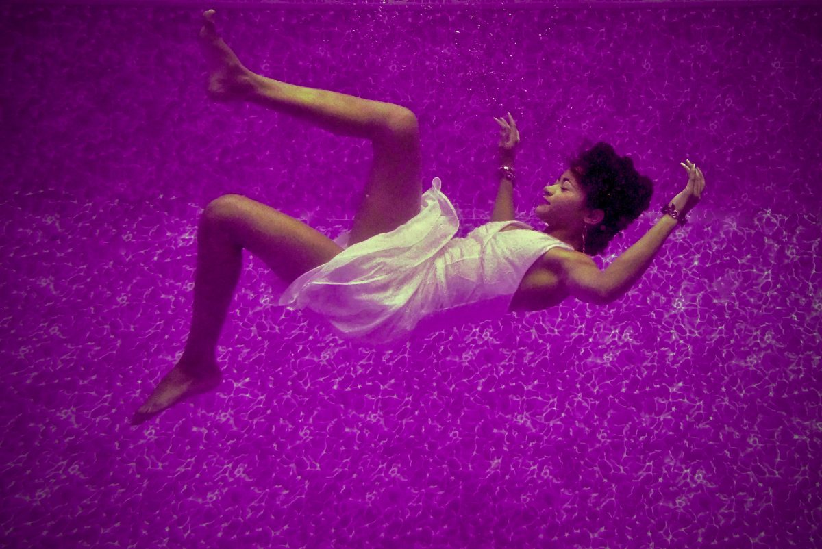 woman floating in purple background