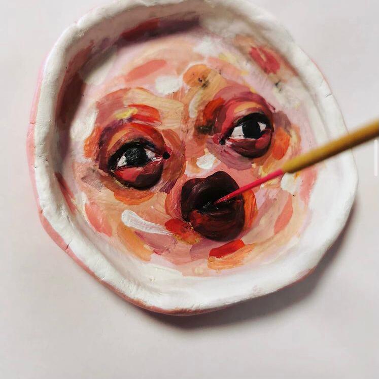 Incense burner of a face with red and pink paint.