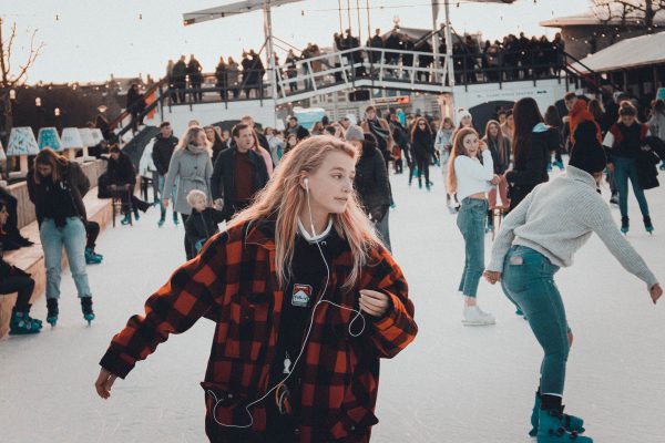 Busy ice rink with people skating