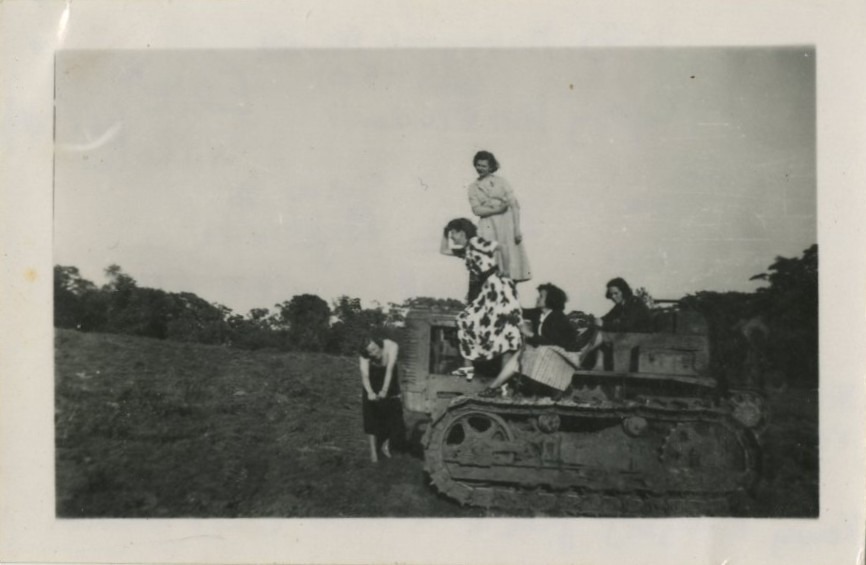 five students on a structure in a field