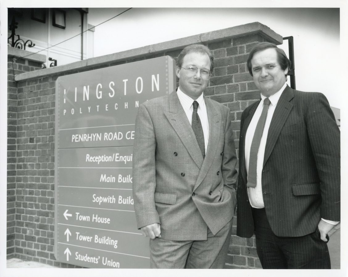 David Miles and a guest standing next to a information sign at Kingston polytechnic. 