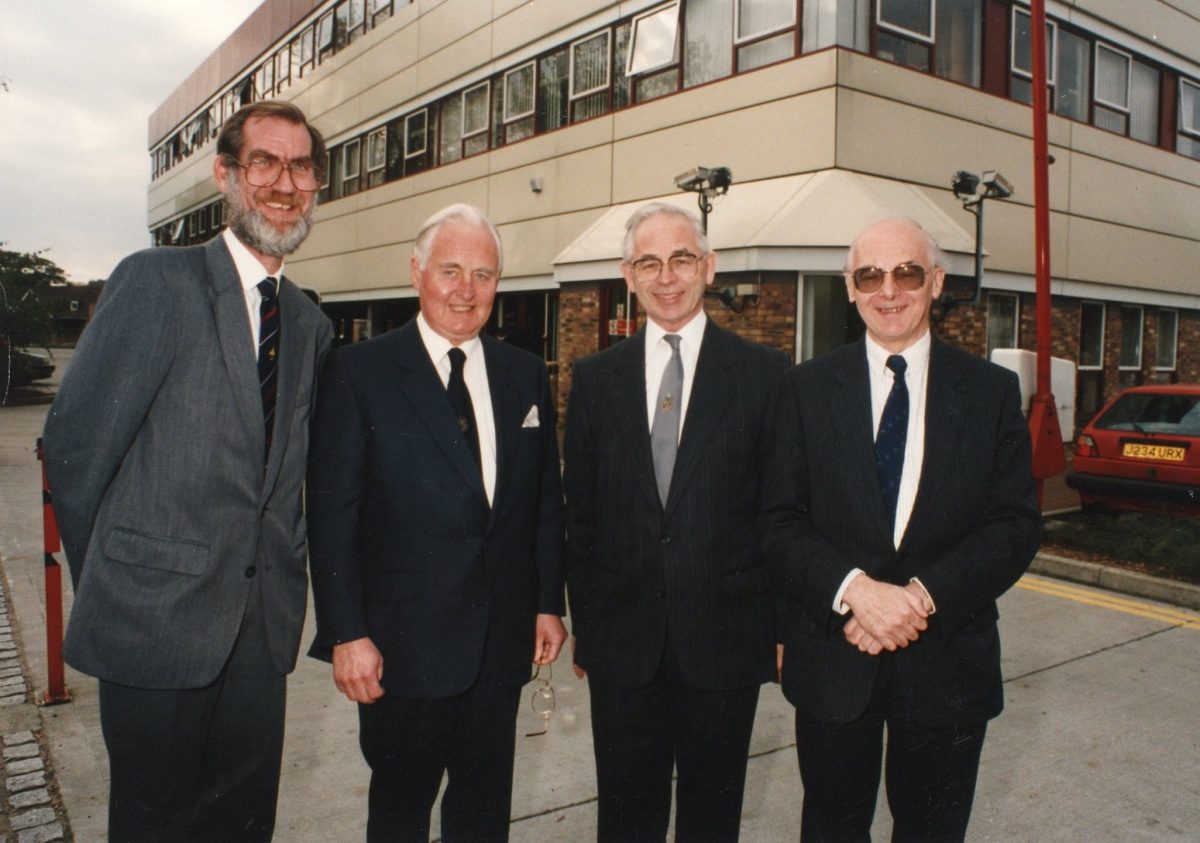 Sir William Barlow with three other men infront of Roehampton Vale campus