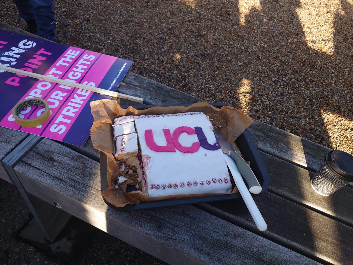 A cake shaped with the UCU logo.