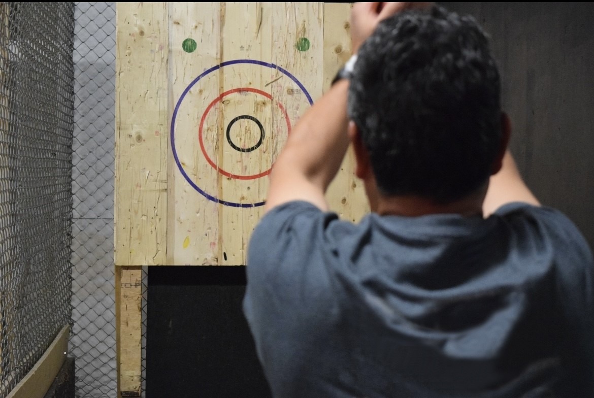 Man about to throw an axe at a target