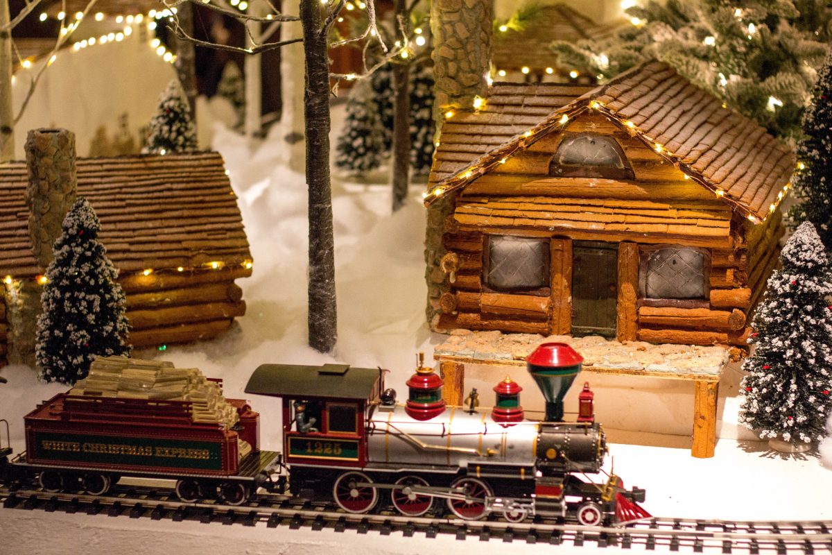 Mini train on the tracks around a gingerbread creation