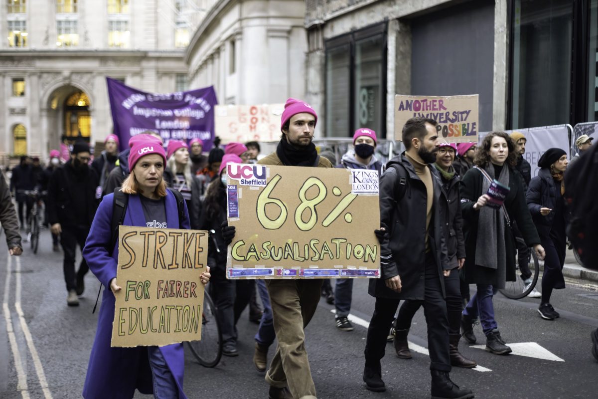 protesters marching in central London. Two signs read 'strike for fairer education' and '68% casualisation'