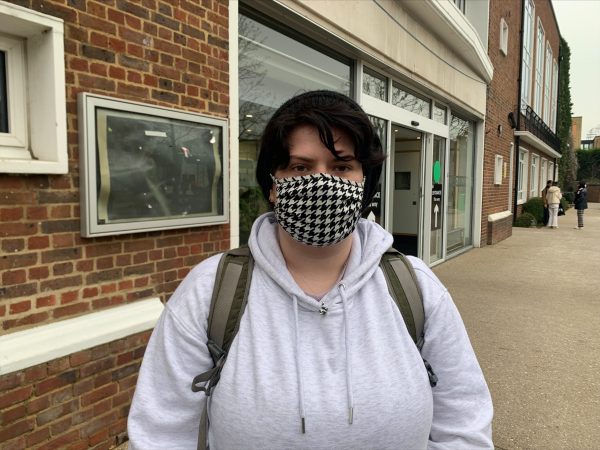 One person standing outside wearing a face mask
