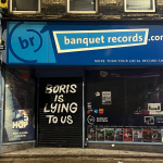 Banquet records displaying 'Boris is lying to us' on their shutters