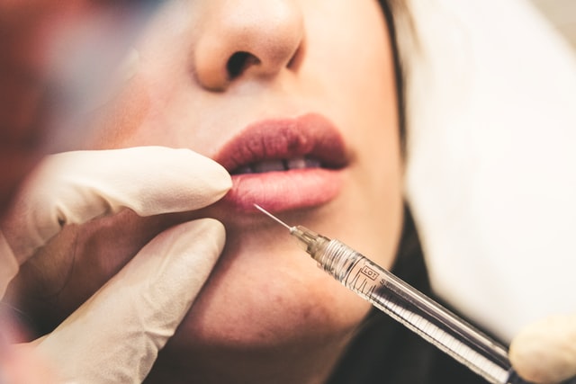 girl getting injections in her lips.