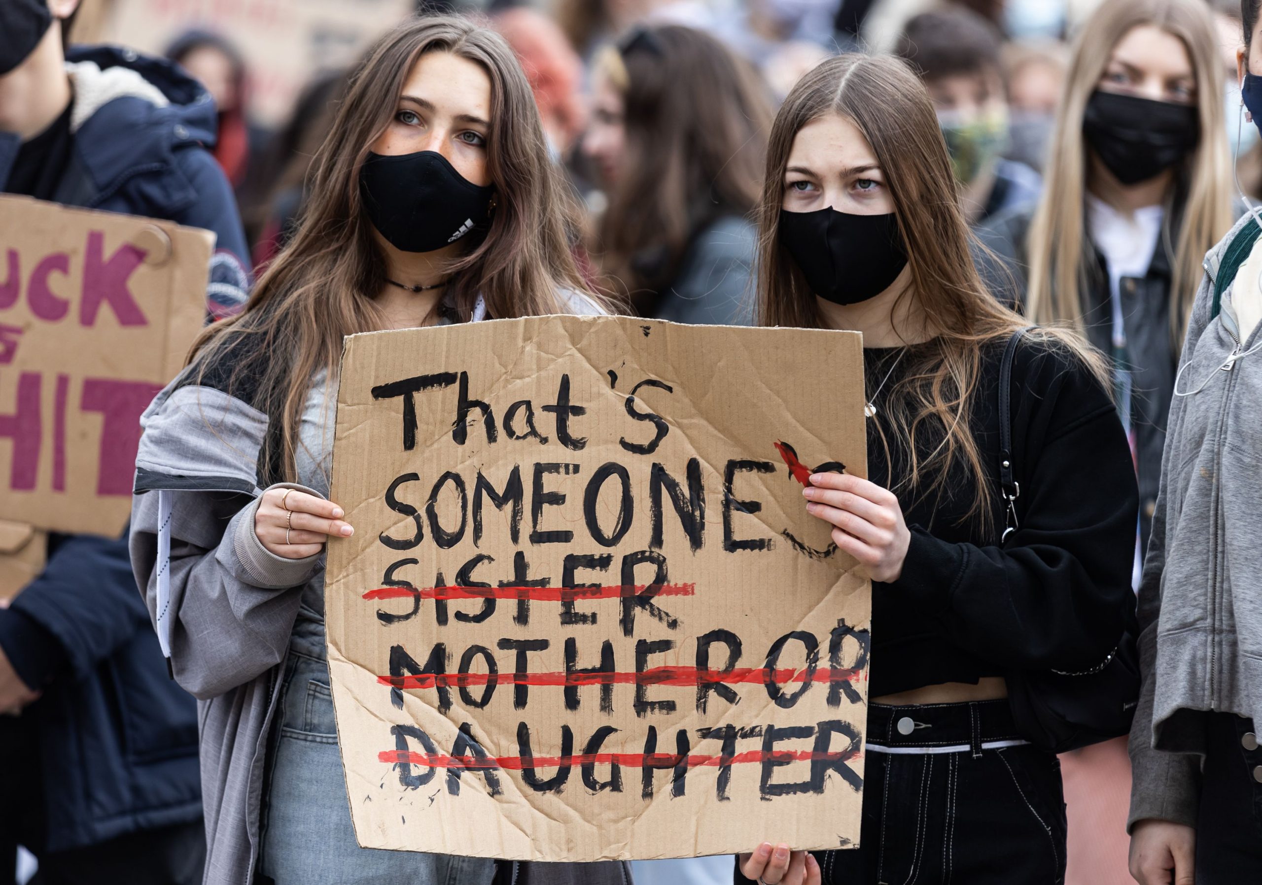 Protest sign reading "That's someone's sister, mother, daughter"