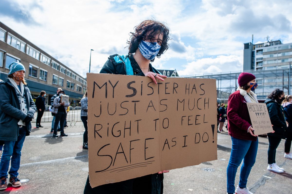 Protest sign reading "My sister has just as much right to feel safe as I do!"