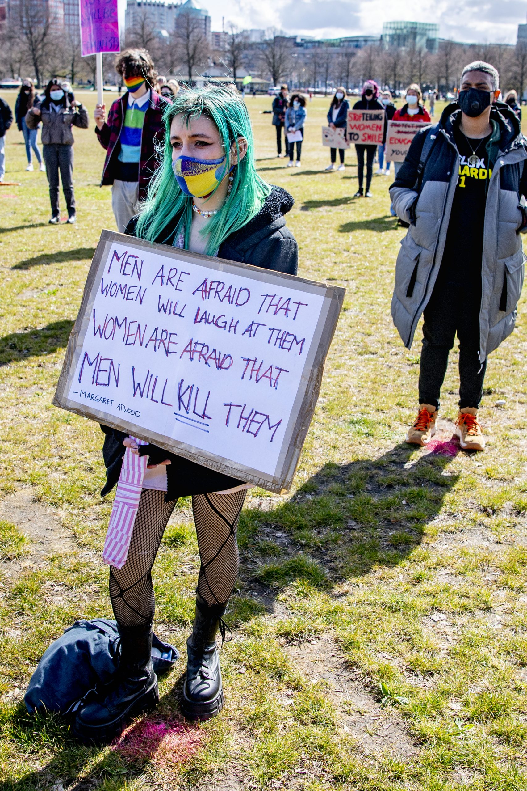 Protest sign reading "Men are afraid that women will laugh at them, women are afraid men will kill them"