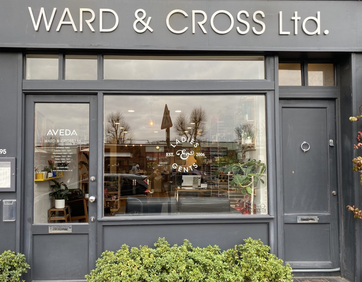Ward & Cross from the outside. Plants can be spotted through the window.