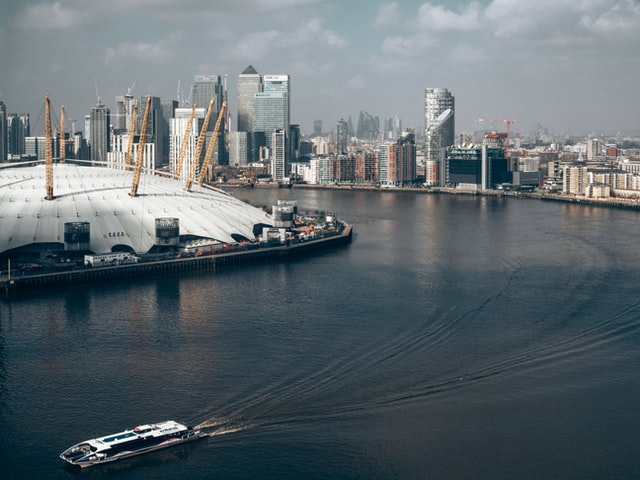 the o2 arena with a boat in the river