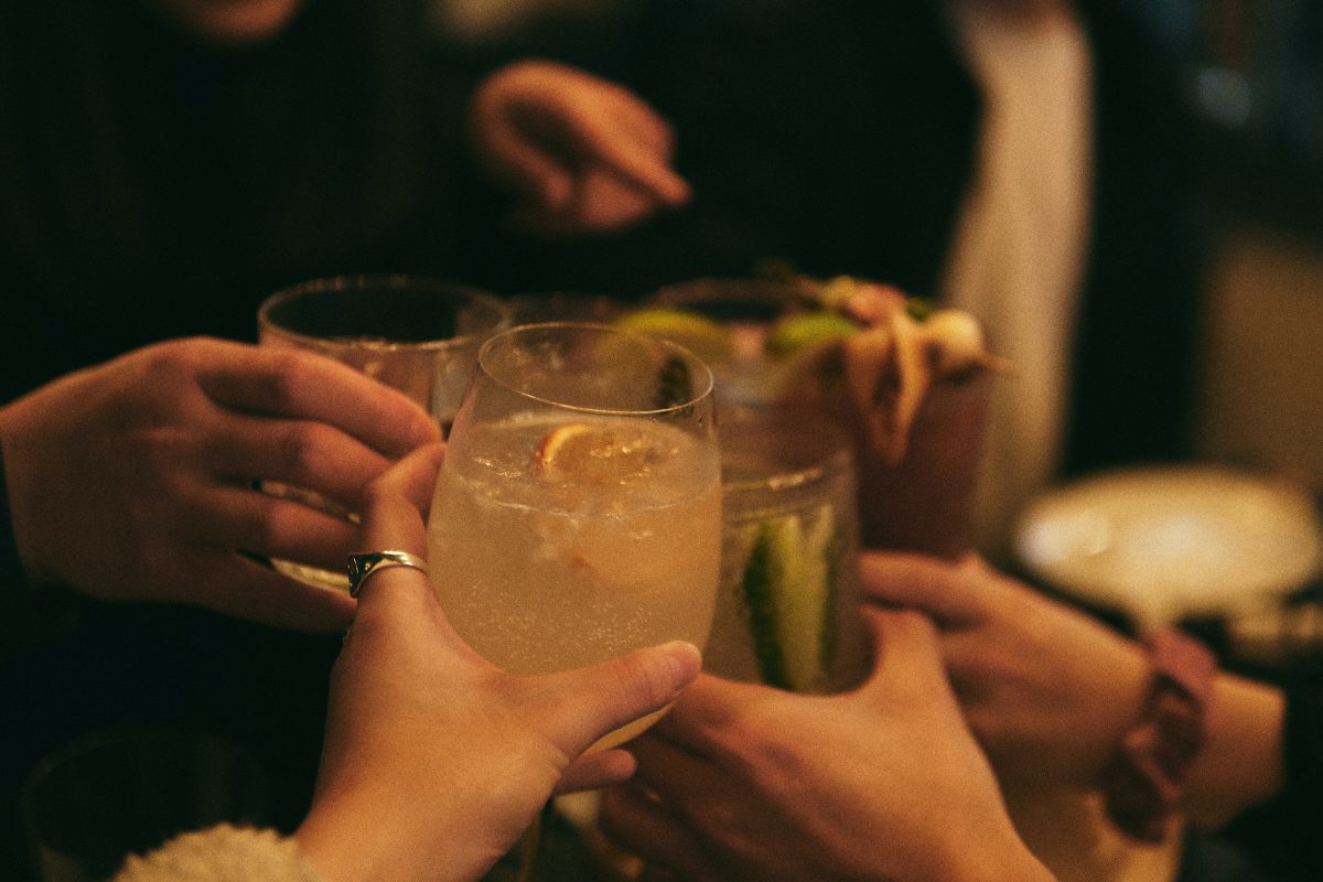 People clinking their glasses together at a bar