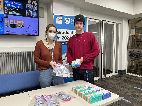 Two people holding reusable period products