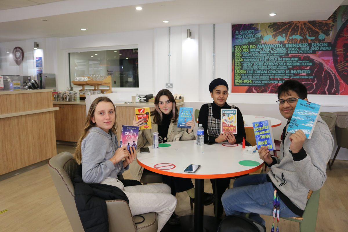 Four students holding the Big Read books