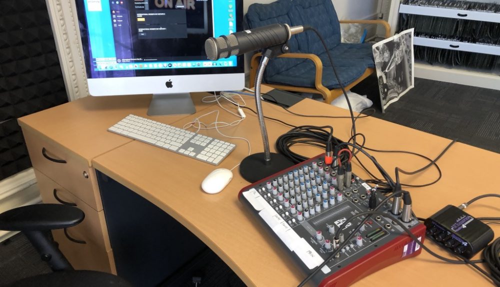 microphone, computer and turntable on a desk