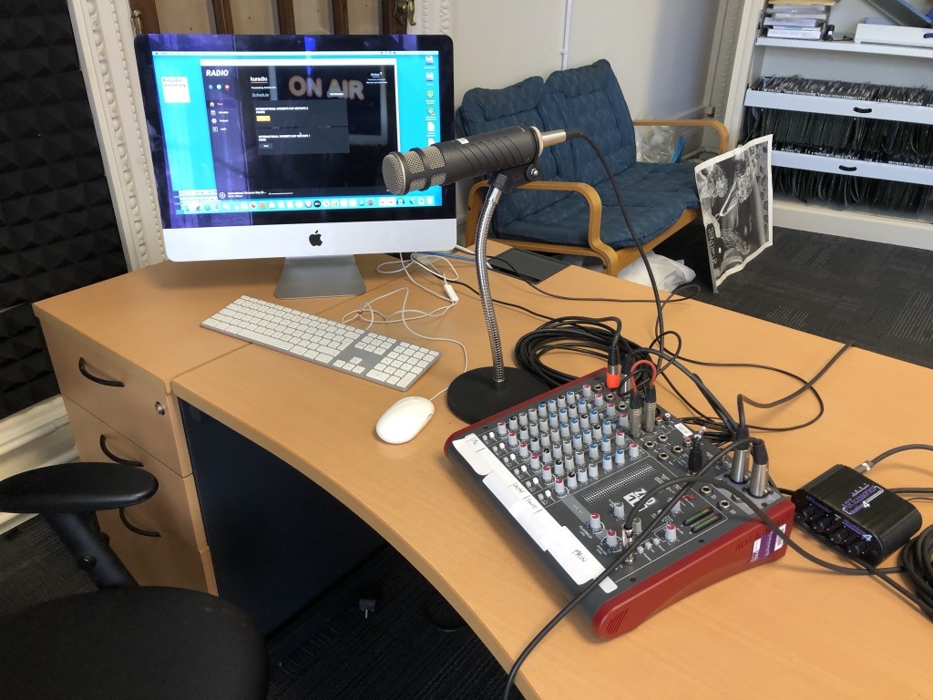 microphone, computer and turntable on a desk