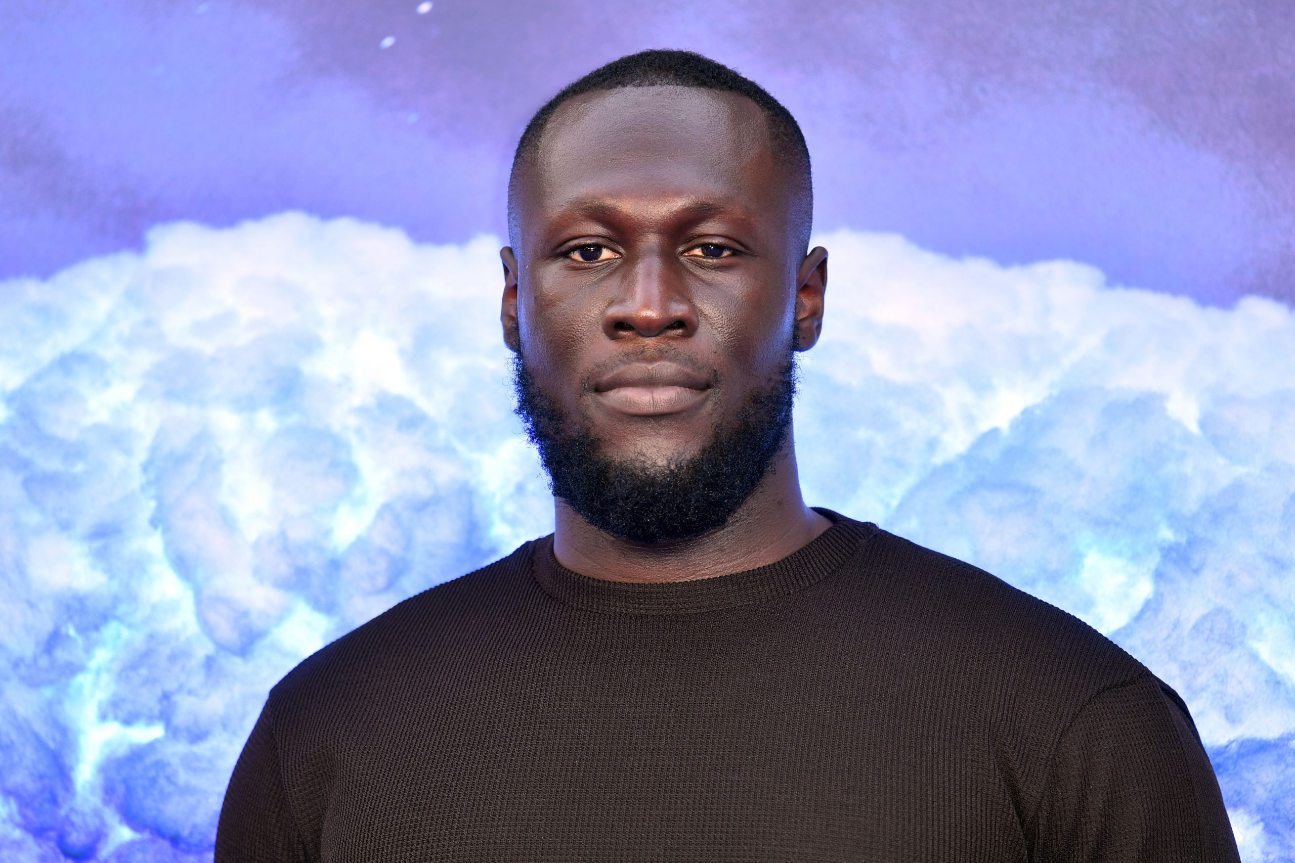 Stormzy in a black shirt at a premiere