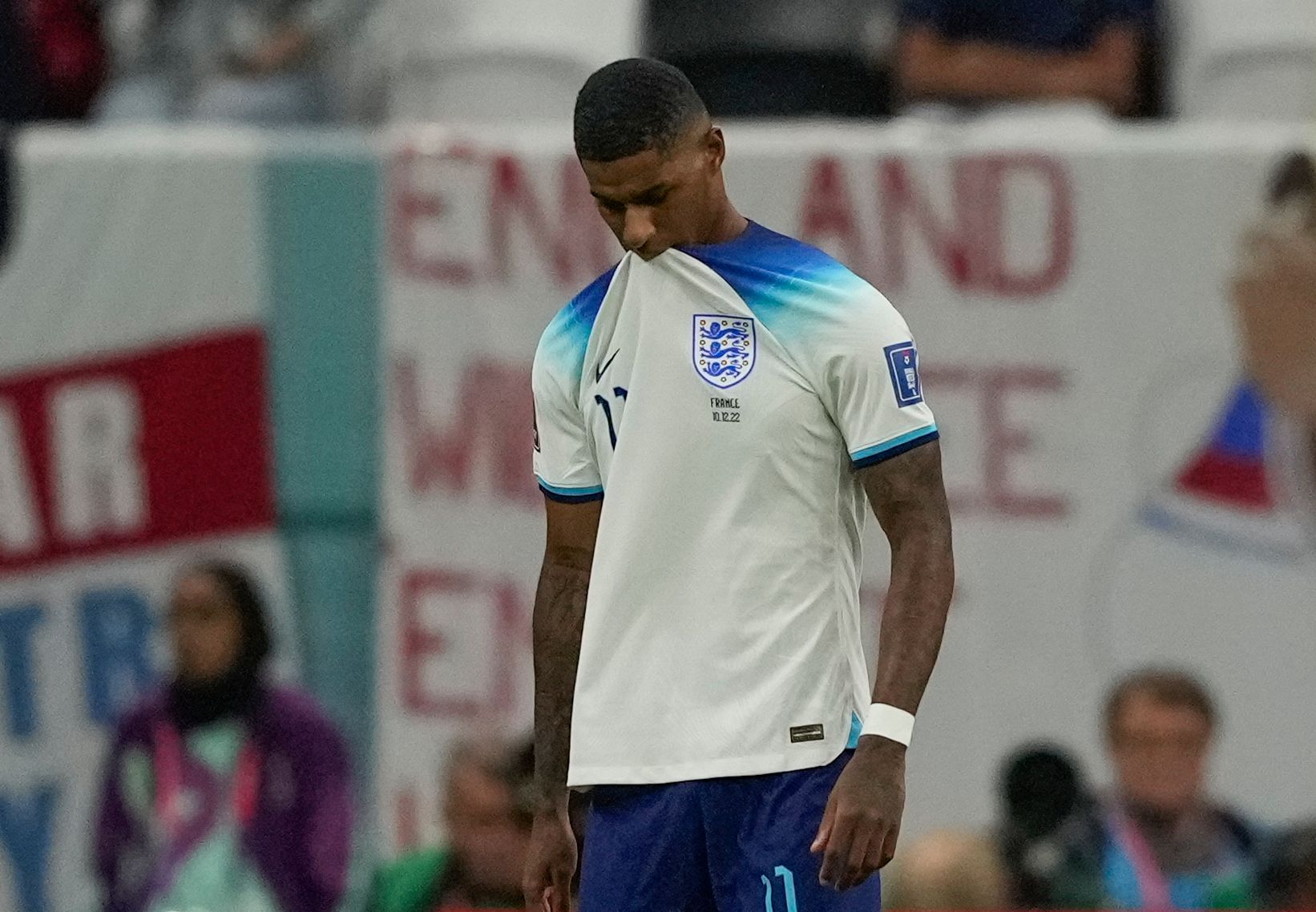 Marcus Rashford biting on his England shirt with a sad look on his face after he missed the free kick