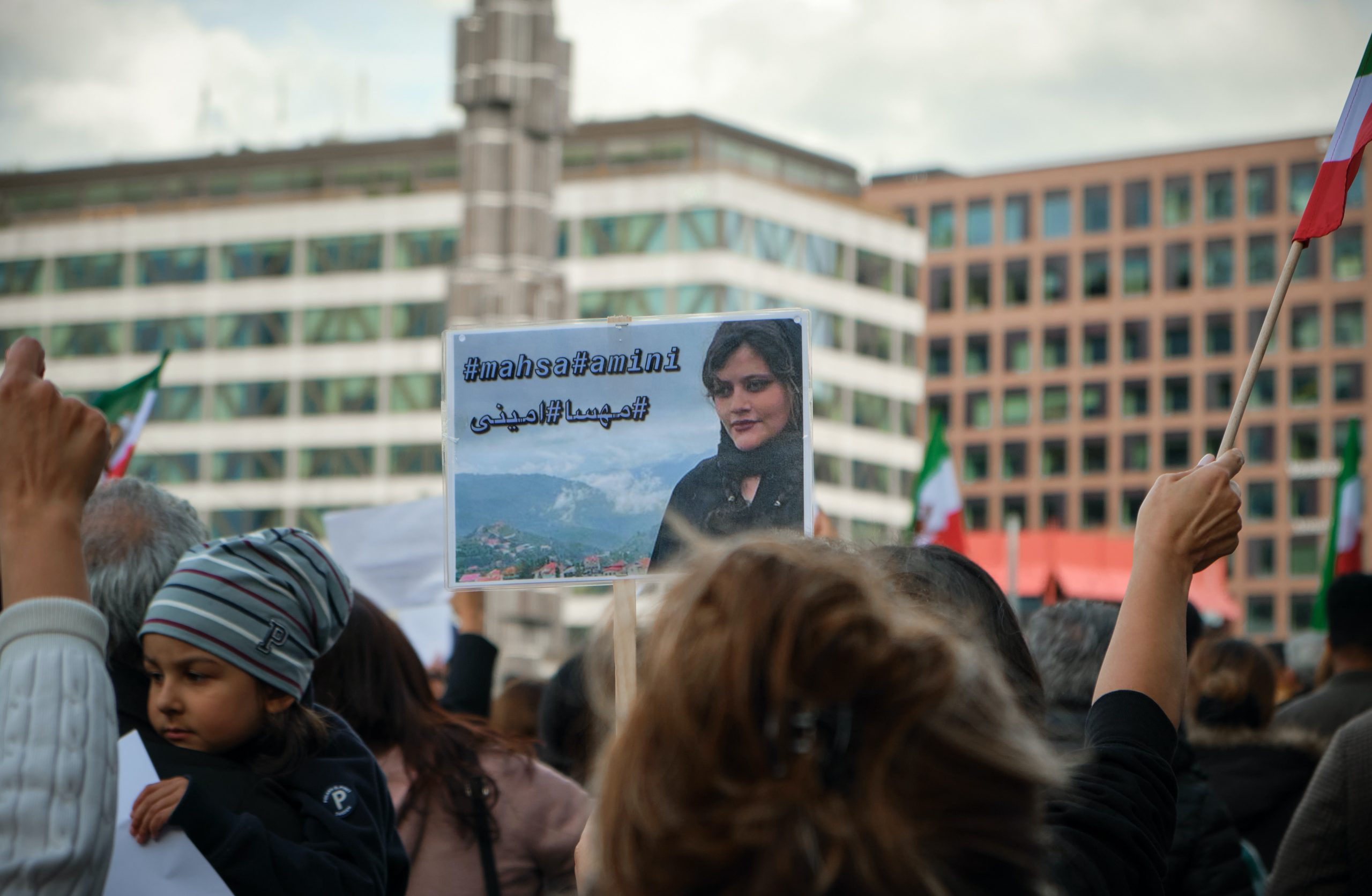 Protestors holding sign with the face of Mahsa 'Jina' Amini