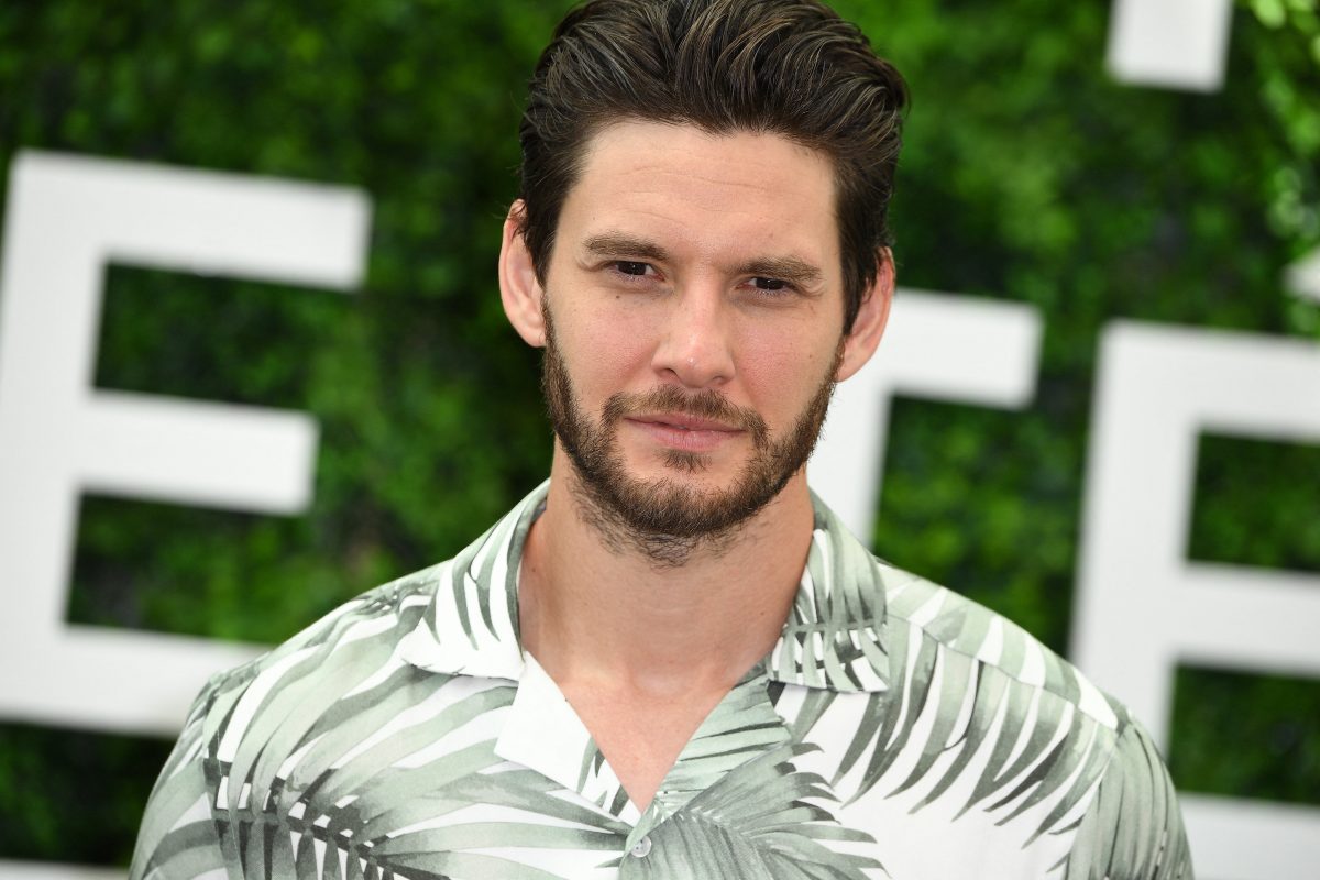 Close up of Ben wearing a green and white Hawaiian shirt. 