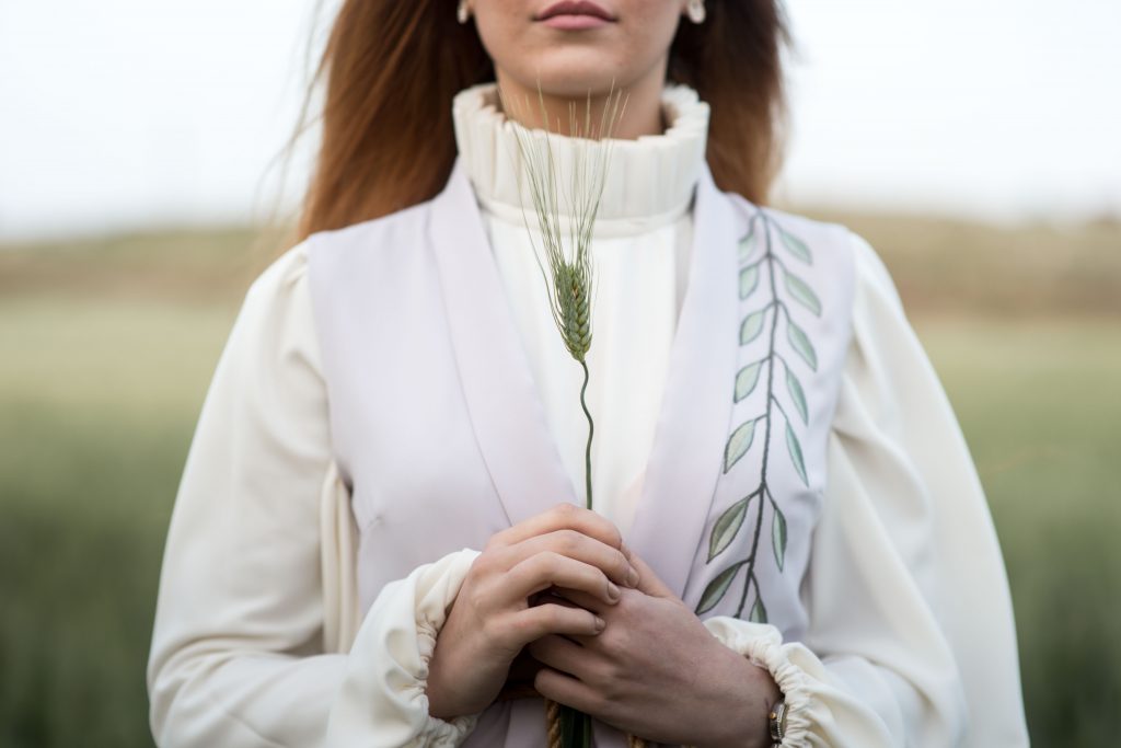 woman holding wheat in a field 