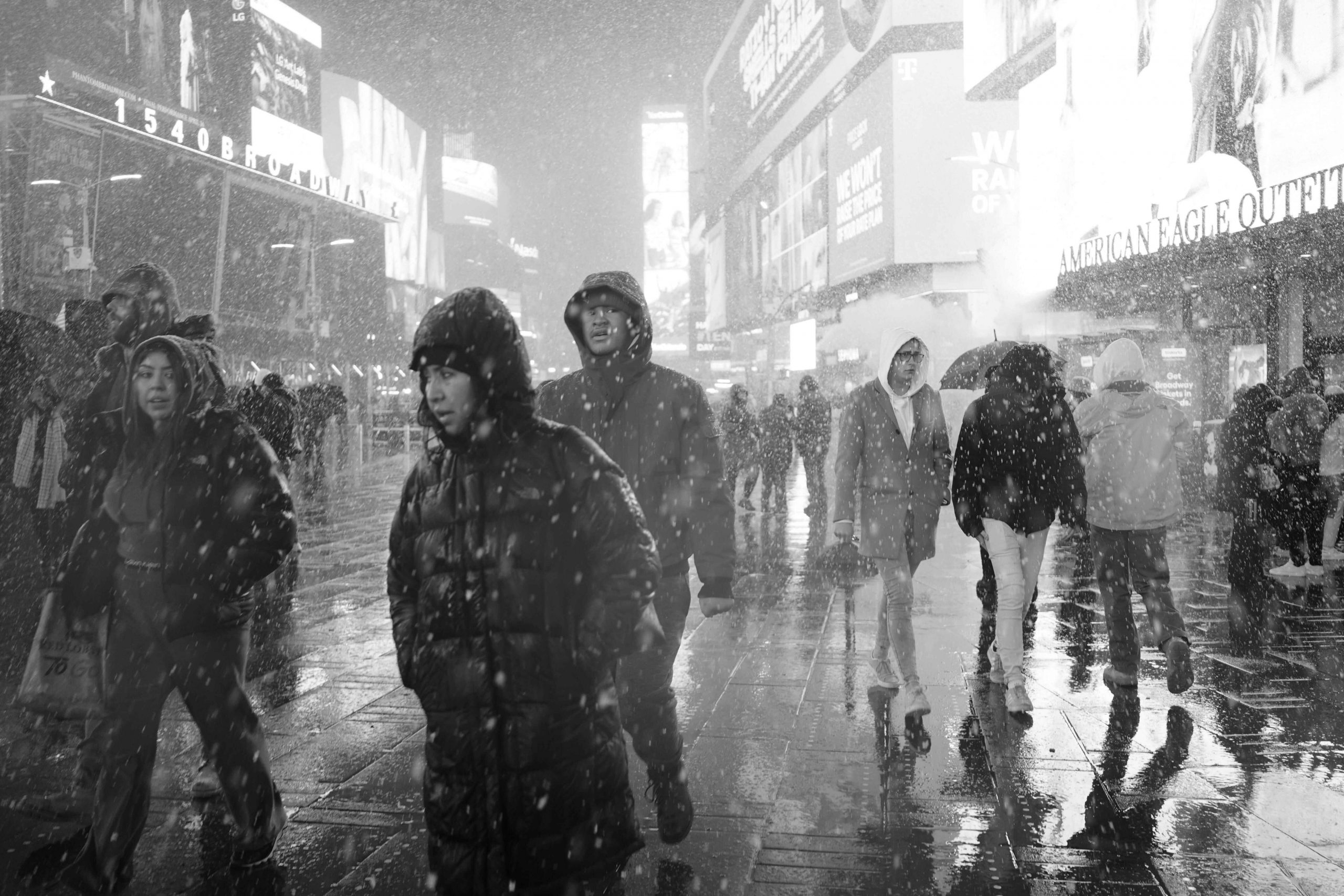 People Walking in Snow in City