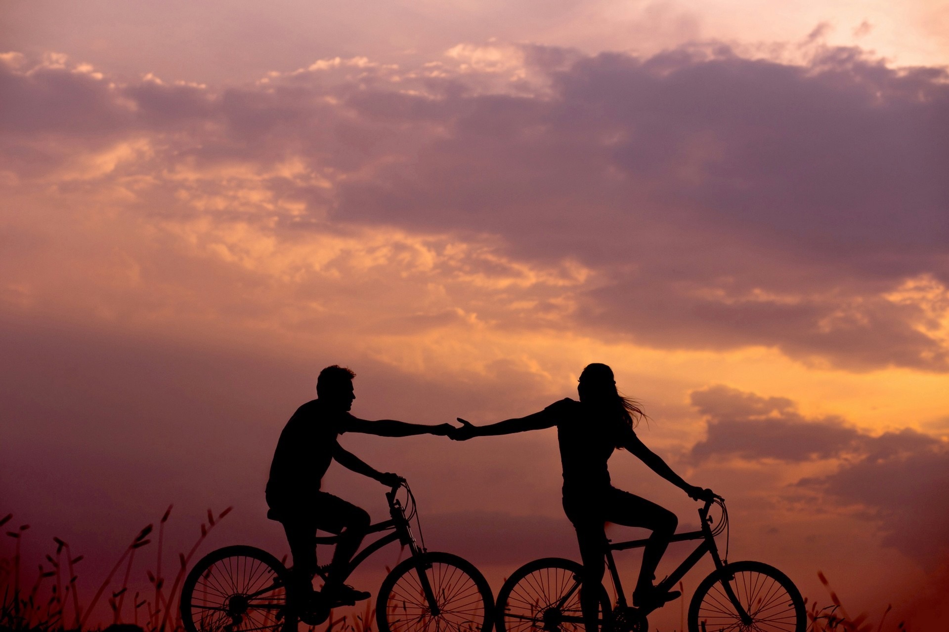 Couple riding bikes together lovingly